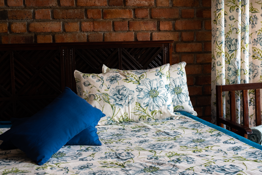 beige floral bed sheet with blue border